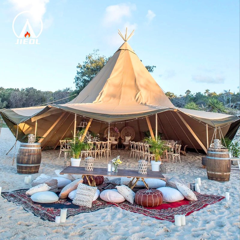 Tipi tent with open sides set up for an outdoor event on the beach Tipi tent with open sides set up for an outdoor event on the beach